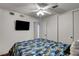 Bedroom with ceiling fan, television, closet and a comfortable queen-sized bed with colorful comforter at 4990 Spring Oak St, Las Vegas, NV 89120