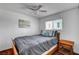 Bedroom featuring a window, ceiling fan, and a comfortable queen-sized bed with a grey comforter at 4990 Spring Oak St, Las Vegas, NV 89120
