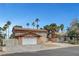 Two-story home boasting a large driveway and desert landscaping, offering a blend of comfort and style at 4990 Spring Oak St, Las Vegas, NV 89120