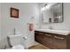 Modern half bathroom with a sleek vanity, toilet with a bidet, and framed mirror at 4990 Spring Oak St, Las Vegas, NV 89120