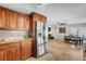 Kitchen with stainless steel refrigerator, granite counters, and adjoining dining area at 4990 Spring Oak St, Las Vegas, NV 89120