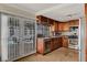 Bright kitchen features wood cabinets, stainless steel appliances, and access to the outdoor pool area at 4990 Spring Oak St, Las Vegas, NV 89120
