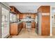 Well-equipped kitchen with wooden cabinets, stainless steel appliances, and convenient access to the outdoors at 4990 Spring Oak St, Las Vegas, NV 89120