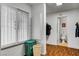 Bright laundry room with a built-in storage cabinet and convenient access to the half bath at 4990 Spring Oak St, Las Vegas, NV 89120