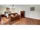 Spacious Living Room with hardwood floors, couch, and a comfortable king-sized bed at 4990 Spring Oak St, Las Vegas, NV 89120