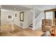 Spacious living room featuring travertine floors, a staircase, and ample seating at 4990 Spring Oak St, Las Vegas, NV 89120