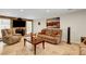 Comfortable living room featuring travertine floors, a stone fireplace, and cozy seating arrangements at 4990 Spring Oak St, Las Vegas, NV 89120