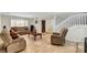 Cozy living room featuring travertine floors, a staircase, and comfortable sofas, creating a relaxing atmosphere at 4990 Spring Oak St, Las Vegas, NV 89120