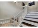Carpeted staircase features white risers, wooden treads, and a decorative railing at 4990 Spring Oak St, Las Vegas, NV 89120