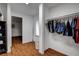 Spacious walk-in closet with built-in shelving and easy access to the laundry and half bath at 4990 Spring Oak St, Las Vegas, NV 89120