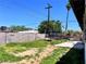 Spacious backyard with potential featuring a trampoline, patio area, block wall, and mature trees for privacy at 5804 Apple Valley Ln, Las Vegas, NV 89108