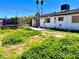 Large backyard featuring ample space, a trampoline, a patio area, and partial fencing for a private outdoor space at 5804 Apple Valley Ln, Las Vegas, NV 89108