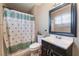 Bathroom with tub/shower combination and dark vanity at 5804 Apple Valley Ln, Las Vegas, NV 89108