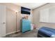 Bedroom with carpet, blue accent dresser, and a mounted TV at 5804 Apple Valley Ln, Las Vegas, NV 89108