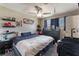 Bedroom with carpet, a ceiling fan, dark blue accents, and built in shelving at 5804 Apple Valley Ln, Las Vegas, NV 89108