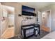 Bedroom with carpet, tv and an attached bathroom and view of the hallway at 5804 Apple Valley Ln, Las Vegas, NV 89108