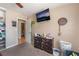 Bedroom showcasing closet storage, and a wall-mounted TV above a dark dresser and a view into an adjacent room at 5804 Apple Valley Ln, Las Vegas, NV 89108