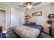 Bedroom with carpet, closet, ceiling fan, dark blue accents, and built in shelving at 5804 Apple Valley Ln, Las Vegas, NV 89108