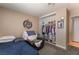 Bedroom with carpet, twin bed, closet and a dart board on the wall at 5804 Apple Valley Ln, Las Vegas, NV 89108