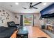 Living room features wood floors, brick fireplace, ceiling fan, and backyard access at 5804 Apple Valley Ln, Las Vegas, NV 89108