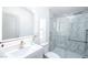 Bathroom featuring a marble tile shower and tub combination plus a single sink vanity with a lighted mirror at 5822 E Carey Ave, Las Vegas, NV 89156