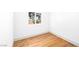 Bright bedroom with a window bringing in natural light and wood-look flooring at 5822 E Carey Ave, Las Vegas, NV 89156