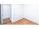 Bedroom featuring wood-look flooring, closet with sliding doors, and white walls at 5822 E Carey Ave, Las Vegas, NV 89156
