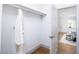 Walk-in closet showcasing an open view to a bedroom with a queen size bed near a window at 5822 E Carey Ave, Las Vegas, NV 89156