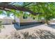 Exterior view of a manufactured home with gravel landscaping and a shade tree at 5822 E Carey Ave, Las Vegas, NV 89156