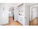 Hallway including a built-in cabinet and drawers leading to an open-concept kitchen and another room at 5822 E Carey Ave, Las Vegas, NV 89156