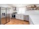 Modern kitchen featuring stainless appliances, white cabinetry, subway tile backsplash, and hardwood floors at 5822 E Carey Ave, Las Vegas, NV 89156