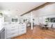 Open-concept floor plan featuring a bright kitchen, dining area, and a cozy living space with white walls at 5822 E Carey Ave, Las Vegas, NV 89156