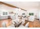 Open concept home featuring a kitchen, dining, and living area with hardwood floors and exposed beam at 5822 E Carey Ave, Las Vegas, NV 89156