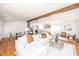 Open-concept living room with exposed beams, hardwood floors, and seamless flow to kitchen and dining at 5822 E Carey Ave, Las Vegas, NV 89156