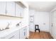 Mud room with storage cabinets and quartz countertop near a back door and laundry hook ups at 5822 E Carey Ave, Las Vegas, NV 89156