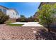 The backyard includes a small patch of turf for activities and a large area for entertaining at 5912 Kit Cove Ct, Las Vegas, NV 89131