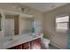 Bright bathroom features double sinks, a large mirror, and a shower-tub combo at 5912 Kit Cove Ct, Las Vegas, NV 89131