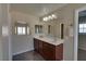 Bathroom with a double vanity, mirror and modern lighting at 5912 Kit Cove Ct, Las Vegas, NV 89131