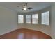 A serene bedroom with ample natural light and wood floors and ceiling fan at 5912 Kit Cove Ct, Las Vegas, NV 89131