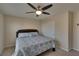 Cozy bedroom featuring a ceiling fan, plush carpeting and blue patterned bedspread at 5912 Kit Cove Ct, Las Vegas, NV 89131