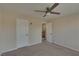 Bright bedroom with neutral walls, carpet, and ceiling fan at 5912 Kit Cove Ct, Las Vegas, NV 89131