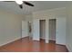 Spacious bedroom with wood floors, ceiling fan, and large closets at 5912 Kit Cove Ct, Las Vegas, NV 89131