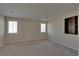 Comfortable bedroom with neutral walls, carpet flooring, natural lighting, and a built-in bookcase at 5912 Kit Cove Ct, Las Vegas, NV 89131