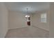 Bright dining room featuring neutral walls, carpet flooring, a chandelier, and a window with white shutters at 5912 Kit Cove Ct, Las Vegas, NV 89131