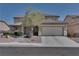 Charming two-story home with a well-maintained front yard and a two car garage on a clear, sunny day at 5912 Kit Cove Ct, Las Vegas, NV 89131