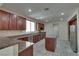 Spacious kitchen featuring cherry wood cabinets, granite countertops, stainless steel appliances, and tile flooring at 5912 Kit Cove Ct, Las Vegas, NV 89131