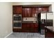 Traditional kitchen features stainless steel appliances and granite countertops and tile floors at 5912 Kit Cove Ct, Las Vegas, NV 89131