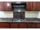 This modern kitchen features a stainless steel cooktop and a beautiful backsplash at 5912 Kit Cove Ct, Las Vegas, NV 89131