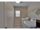 Functional laundry room with a washer, dryer, and shelving at 5912 Kit Cove Ct, Las Vegas, NV 89131