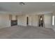 Spacious living room with fireplace, neutral walls and plush carpet at 5912 Kit Cove Ct, Las Vegas, NV 89131